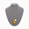 Model wearing Sidonie Baltic amber pendant necklace in cognac and cream amber — handcrafted in Lithuania by AMBER999
